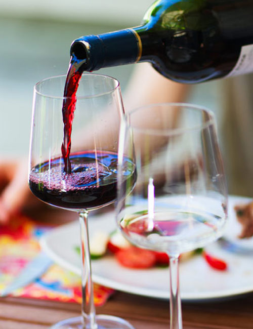 wine being poured from bottle into glass