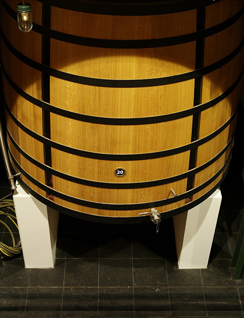 a barrel on two white wood peices